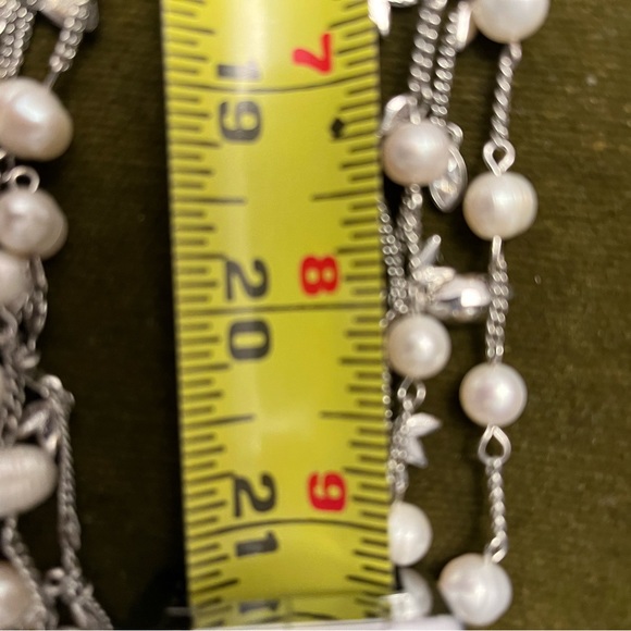 A thin 20” long 2-themed necklace. One necklace has a pearl like design and… - Picture 4 of 5